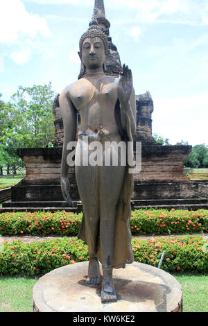 A piedi in bronzo Buddha in wat Sa Si in Sukhotai, Thailandia Foto Stock