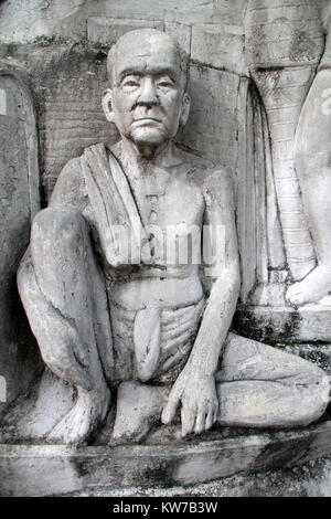 Statua di monaco buddista sulla parete di un monumento nel parco Santichaiprakan, Bangkok, Thailandia Foto Stock