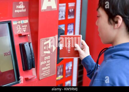 Persona di restituire un filmato Redbox presso un chiosco Redbox Foto Stock