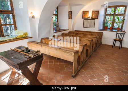 Corsi in aula e panca in legno posti nella prima scuola rumena Museum, quartiere Schei, Brasov, una città in Transilvania centrale regione della Romania Foto Stock