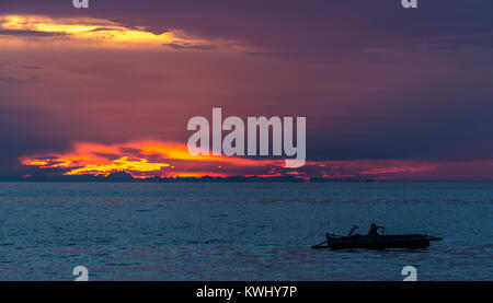 Fisherman trattura nelle sue reti al tramonto Foto Stock