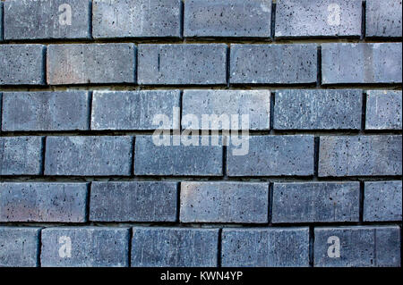 Sfondo astratto e consistenza del quadrato grigio muro di mattoni con configurazione di giunzione. Foto Stock