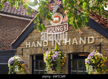 Mano nella mano pub di segnaletica in Wimbledon, Londra Foto Stock