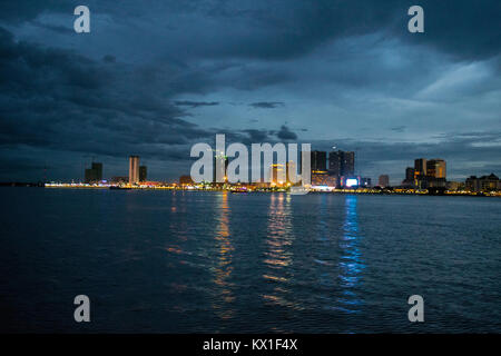 Phnom Penh tramonto tramonto visto dal Mekong e il Tonle Sap fiumi, emergono con sky raschiatori. Stagione dei monsoni e la pioggia nuvole avvicinando alla città Foto Stock