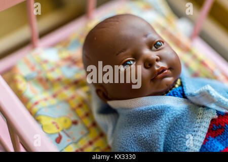 Pelle scura baby doll Vestito in blu Foto Stock