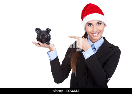 Imprenditrice con santa hat rivolta nel salvadanaio, il risparmio per il natale Foto Stock