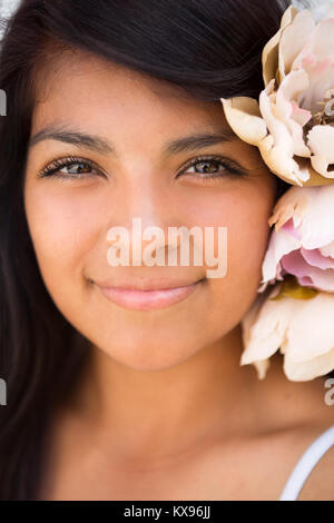 Giovane ragazza ispanica sorridente al di fuori. Foto Stock