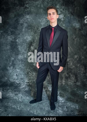 Giovane uomo che indossa un abito nero Foto Stock
