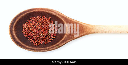 Raw quinoa rossa in un cucchiaio di legno su sfondo bianco Foto Stock