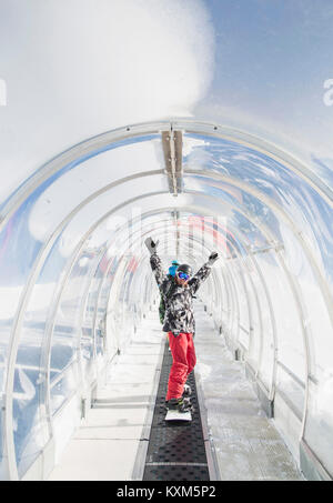 Ritratto di snowboarder in ski run tunnel,su tapis roulant Foto Stock