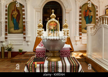 Accessori per il battesimo dei bambini le icone delle candele e del font, Chiesa Ortodossa. Il Sacramento dei bambini del battesimo nella Chiesa Foto Stock