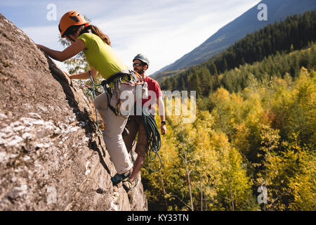 Arrampicatori raggiungendo sulla rupe Foto Stock