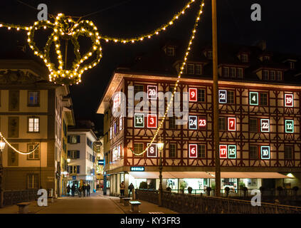 Lucerna, Svizzera - 2 Dicembre 2017: la facciata di una casa a Lucerna mostra un illuminato calendario dell'Avvento come ornamento di Natale. Foto Stock