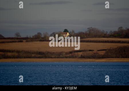 Agriturismo tra campi invernali del Patchwork campagna inglese e al di là della Exe Estuary, da turf Hotel guardando verso Topsham. South Devon, Regno Unito. Foto Stock