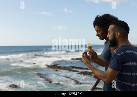 Giovane avente gelato vicino al mare Foto Stock