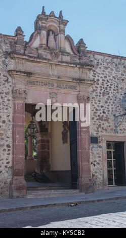 Ingresso anteriore dell'Instituto Allende, con muro di pietra, entrata in pietra, con elaborati intarsi, e strada di ciottoli, in San Miguel De Allende Foto Stock