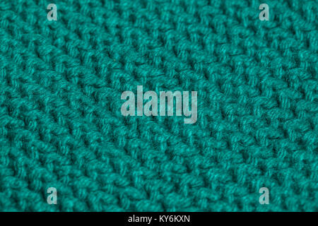 Macro immagine di colore verde di tessitura a maglia. Foto Stock