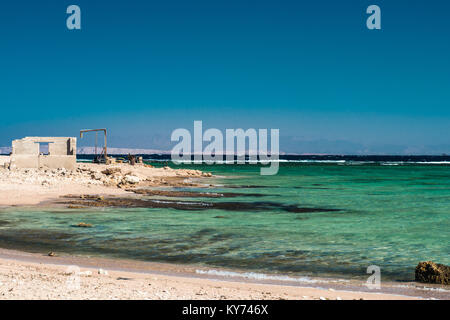 La casa in rovina con le vecchie strutture di metallo sulla riva del mare. Mar Rosso a Sharm El Sheikh, Egitto. Foto Stock