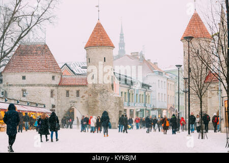 Tallinn, Estonia. Le persone Camminare vicino a Natale Mercatini di Natale su sfondo di Viru cancello in inverno nevoso giorno. Foto Stock