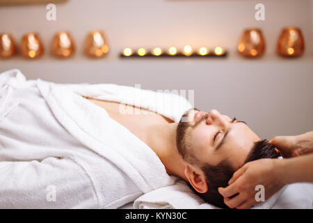 Uomo bello spa durante la sessione di massaggio Foto Stock