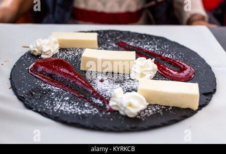 Tradizionale dolce italiano Panna cotta con salsa di fragole e panna montata. Foto Stock