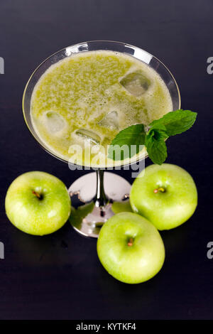 Verde la frutta e la verdura juiced nel bicchiere da cocktail con un rametto di menta Foto Stock