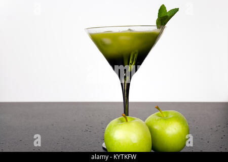 Verde la frutta e la verdura juiced nel bicchiere da cocktail con un rametto di menta Foto Stock