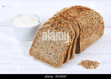 Tutto il grano fetta di pane fette di pane a fette sulla tavola di legno legno Foto Stock