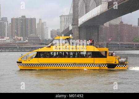 NEW YORK - 3 luglio: Persone corsa taxi d'acqua in caso di pioggia il 3 luglio, 2013 a New York. New York Water Taxi ha 12 navi e serve 1,370 corse al giorno. Foto Stock