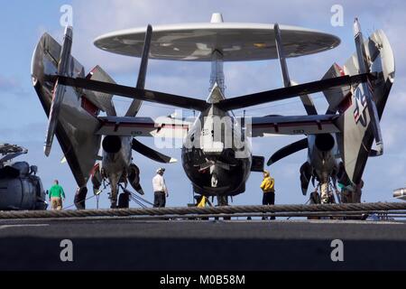 Velisti assegnati alla Nimitz-class portaerei USS Carl Vinson (CVN 70) eseguire la pre-controlli di volo su un E-2C Hawkeye in preparazione delle operazioni di volo. Foto Stock