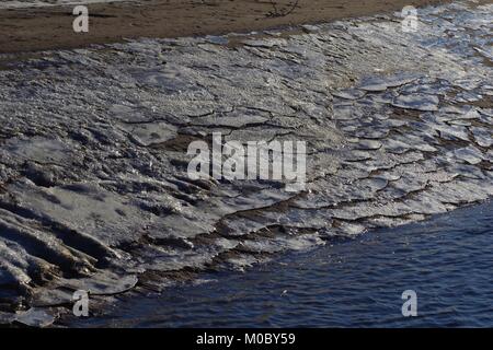 Lastre di ghiaccio sulla riva sabbiosa del Fiume Don a Donmouth natura locale riserva. Spiaggia di Aberdeen, Scozia, Regno Unito. Inverno 2018. Foto Stock