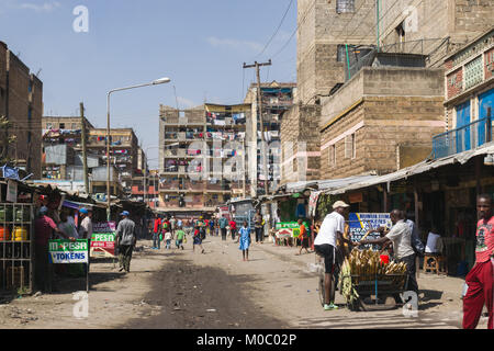 Vista giù per una strada a Huruma, un quartiere di Nairobi, mostrando persone ed edifici, Nairobi, Kenya, Africa orientale Foto Stock