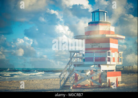 Luminose scenic più vista di esposizione di un iconico a strisce rosse e bianche lifeguard tower con puffy nuvole bianche a South Beach, Miami, Florida Foto Stock