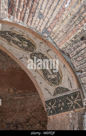 Ostia Antica, Italia - 23 Aprile 2009 - Rosso Mattone rovine con una piastrella Mosaico design in un arco nel sito archeologico della città portuale di antiche Foto Stock