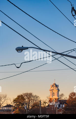 I colori del tramonto il cast di un bagliore di sera della torre dell'orologio di Gwinnett storico tribunale sulla piazza della città e in Lawrenceville, Geaorgia, STATI UNITI D'AMERICA. Foto Stock