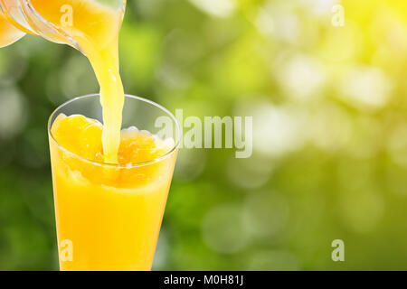 Versare il succo di arancia Foto Stock