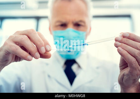 Su scala di guardare il ricercatore del prelievo dei campioni di laboratorio Foto Stock