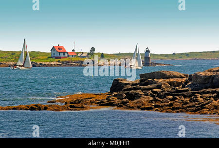 Una coppia di barche a vela passando Ram isola la luce come visto dal punto Ociean, Maine vicino Boothbay, STATI UNITI D'AMERICA Foto Stock