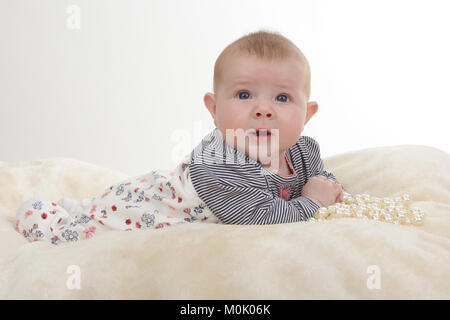 3 mese fa bambina posa sulla pancia sulla coperta Foto Stock