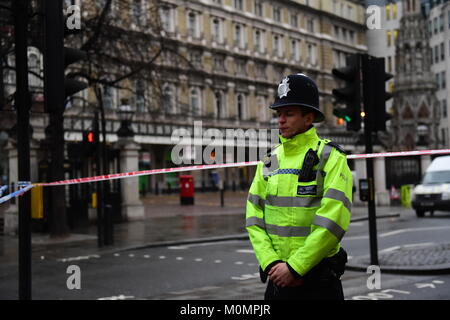 Un funzionario di polizia accanto a un cordone al di fuori di Charing Cross stazione ferroviaria sullo Strand nel centro di Londra dopo alcuni 1.450 persone sono state evacuate da un night club e un hotel e la stazione è stata chiusa a seguito di una perdita da un gas principale. Foto Stock