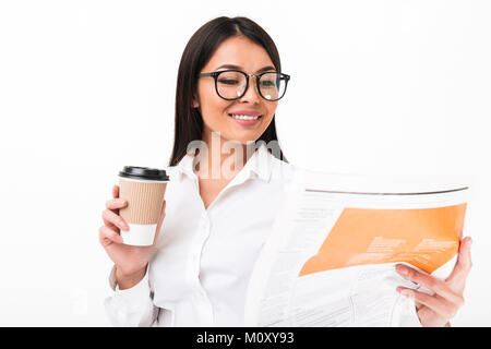 Ritratto di un felice imprenditrice asiatici in occhiali azienda tazza di caffè durante la lettura del giornale isolate su sfondo bianco Foto Stock