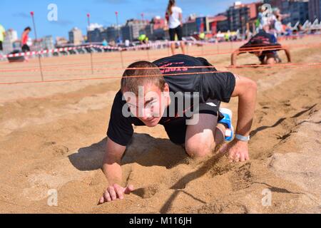 GIJON, Spagna - 19 settembre: Storm Race, una estrema ostacolo corso in settembre 19, 2015 a Gijon, Spagna. Guide di scorrimento è strisciato sotto il filo. Foto Stock