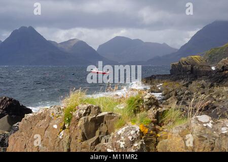 Elgol Harbour, rosso barca da pesca, guardando verso il drammatico Cuillin Hills. Isola di Skye, Hebridies interna, Scotland, Regno Unito. Foto Stock