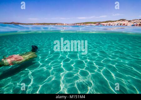 L'Italia, Sardegna, Provincia di Olbia-Tempio, Santa Teresa di Gallura, sul comune di Aglientu, immerso in snorkel di un giovane uomo in blu turchese e acque cristalline della spiaggia di Rena majori o Rena Majore Foto Stock