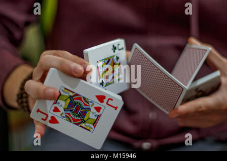 Gli uomini con le mani le carte da gioco Foto Stock