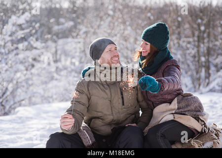 Coppia felice con luci di bengala all'aperto Foto Stock