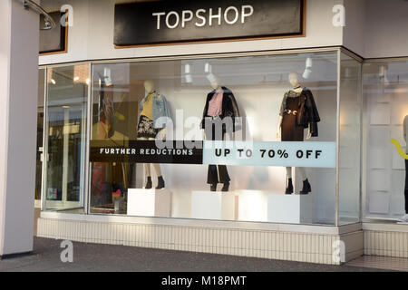 Vendita segni nella finestra di Topshop come riduzioni continuare attraverso gennaio a Bedford Bedfordshire Inghilterra Foto Stock