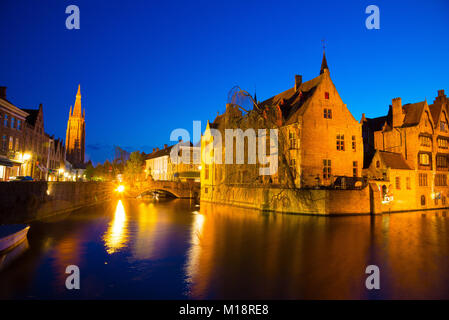 Bruges, Belgio - 18 Aprile 2017: Dock del Rosario - Rozenhoedkaai e Belfry al crepuscolo. La scena di una fiaba medievale di Bruges, Belgio Foto Stock