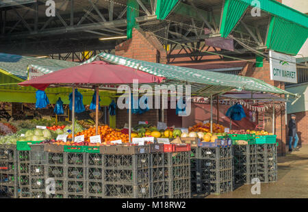 Frutta fresca e verdura stallo, con appeso sacchi da asporto, nel mercato di Peterborough city centre, Cambridgeshire, Inghilterra, Regno Unito. Foto Stock