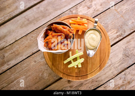 Caldo e ali di pollo piccanti e salsa in pentola. Foto Stock